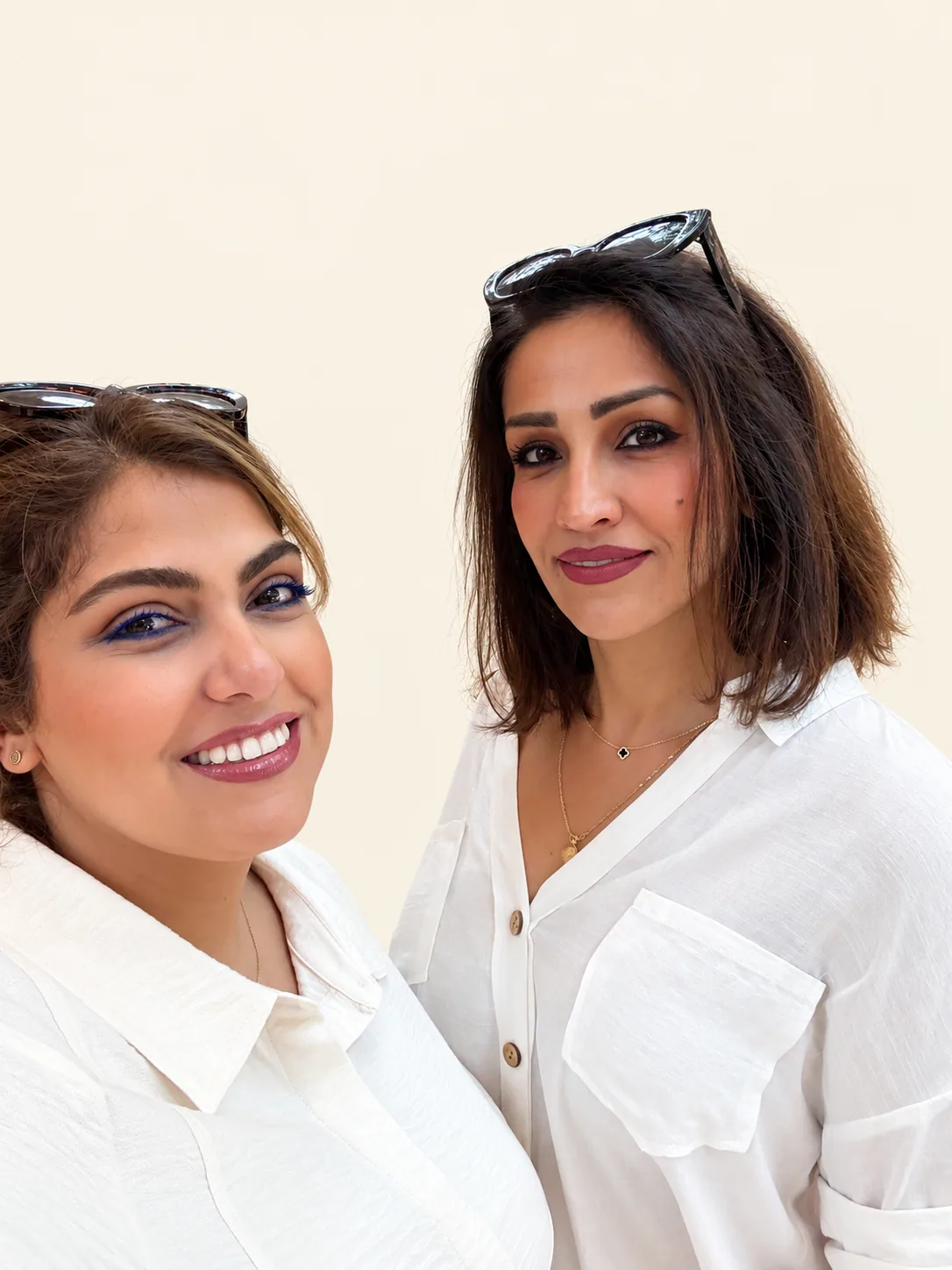 Parastoo and Asal, the founders of House of Balloonz, photographed together against a cream wall.