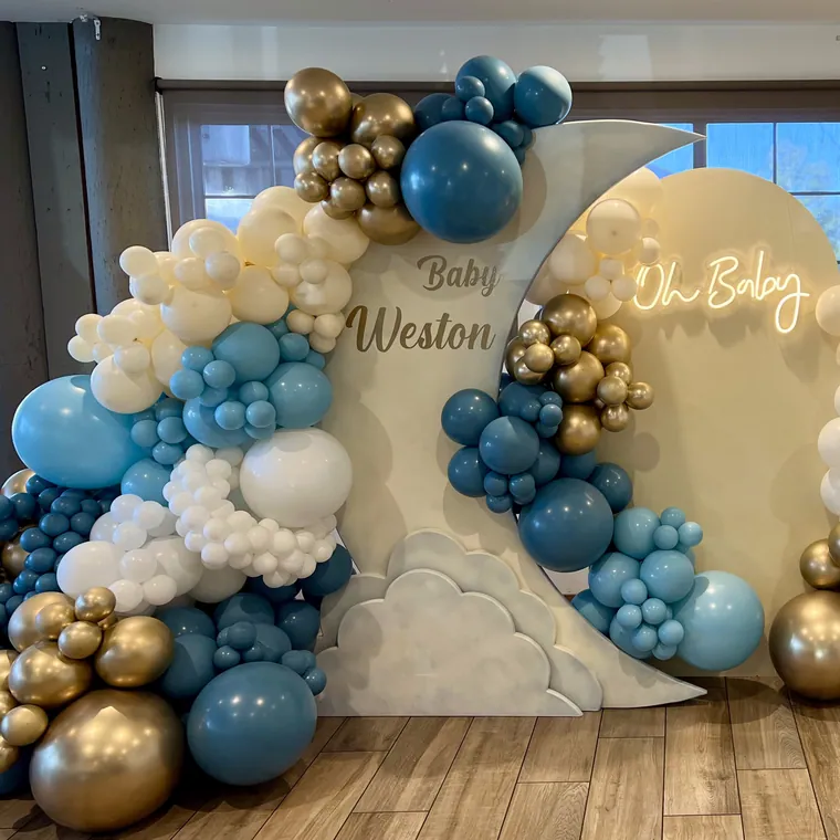Teal, cream and gold balloon backdrop with cloud panels and neon lettering.