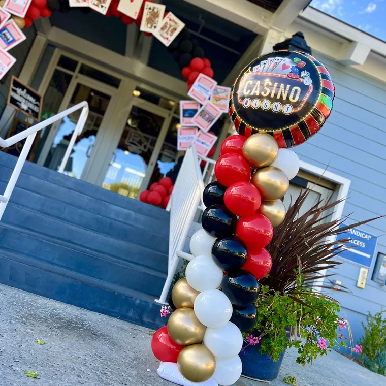 Red, black and gold balloon column beside an entrance.