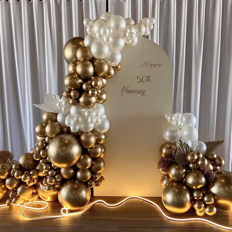 White and gold balloon installation with neon rope lighting.