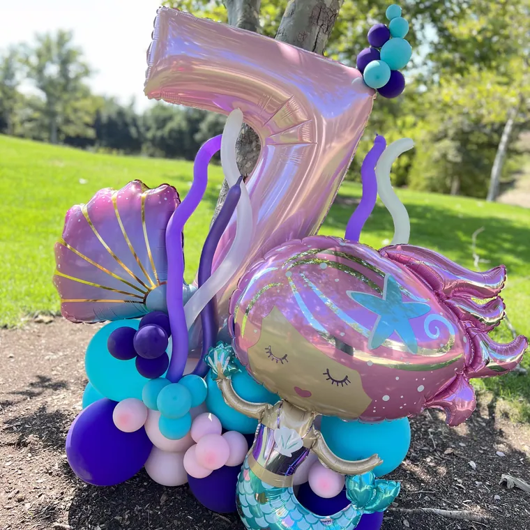 Mermaid themed balloon display in lilac, teal and iridescent foils.