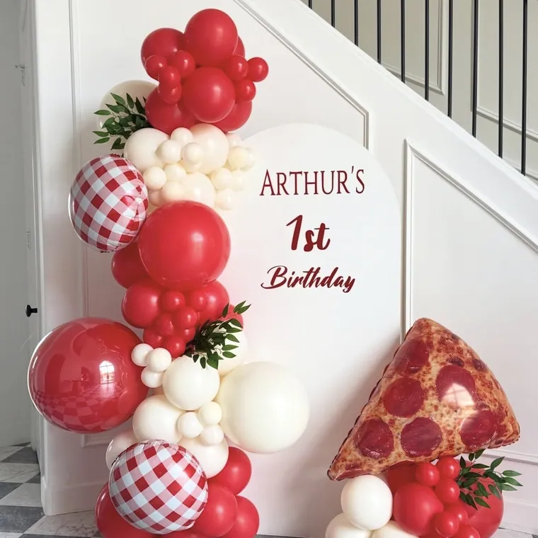 Red gingham and pizza themed first birthday balloon setup.