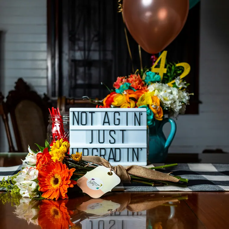 Clear bubble balloon centerpiece above a cream balloon cluster on a table.