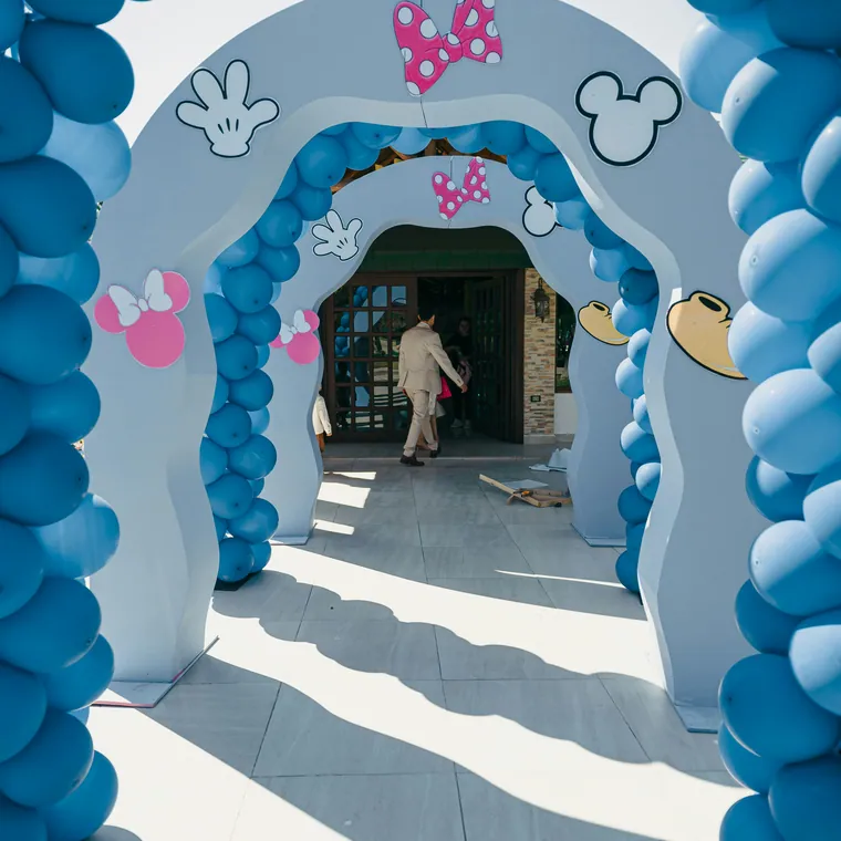 A run of branded balloon arches forming a walkway at a public activation.