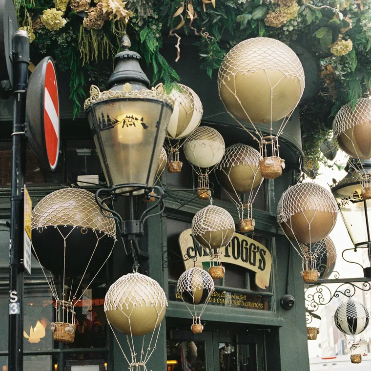 Gold and cream hot air balloon display above a shopfront entrance.