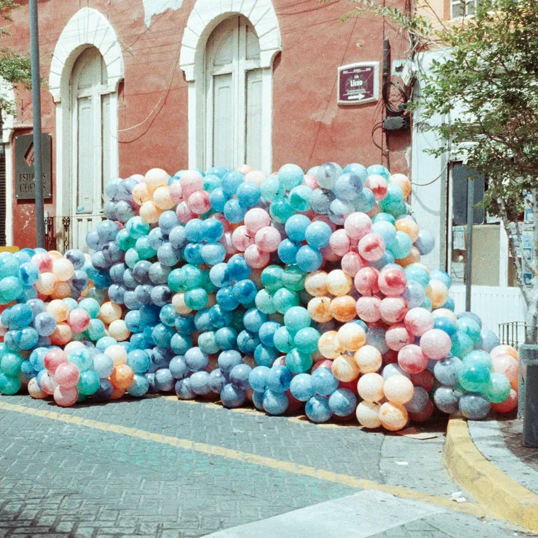 Pastel balloon installation running along a city street.