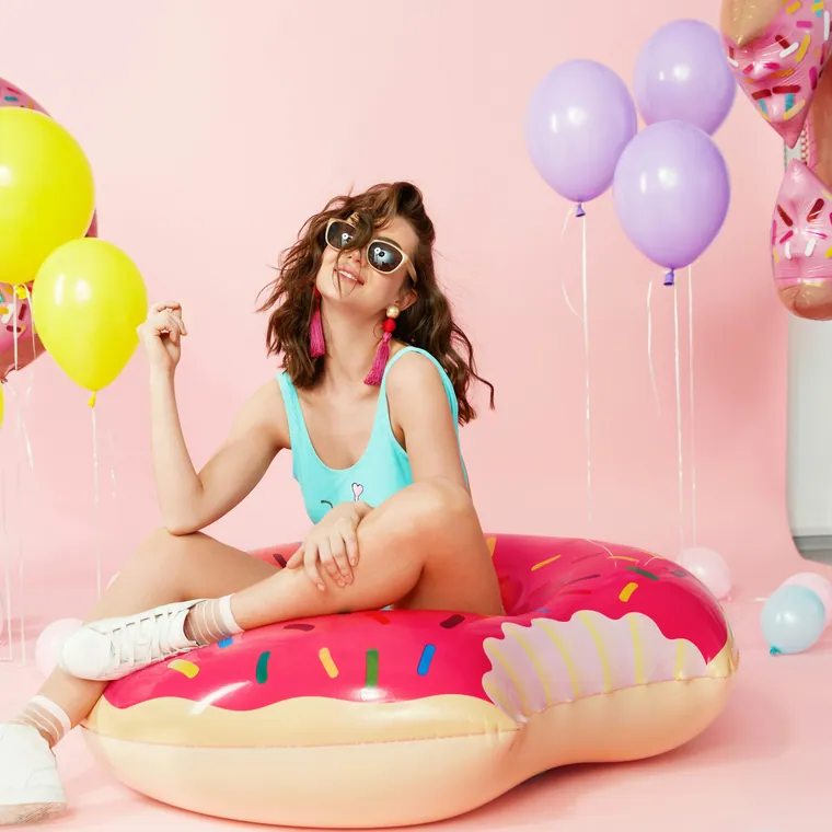 Pool floats and pastel balloons styled together.