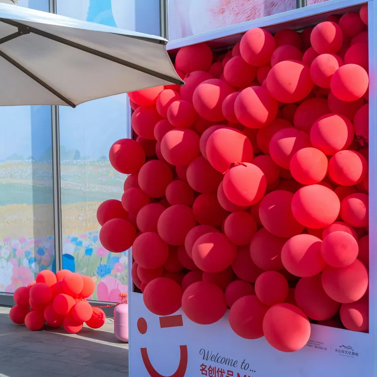 Red balloon wall filling a shop window as a retail display.